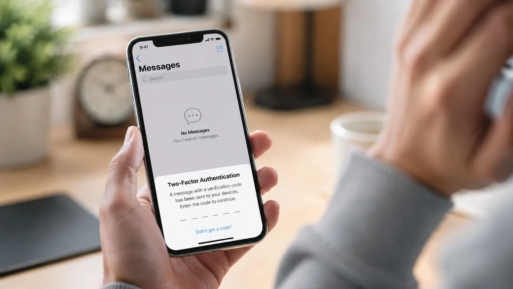 A person holding an iPhone displaying a two-factor authentication prompt while inside the empty messages app.